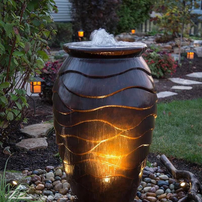 Scalloped Urn fountains at night, lit with spotlights sold separately