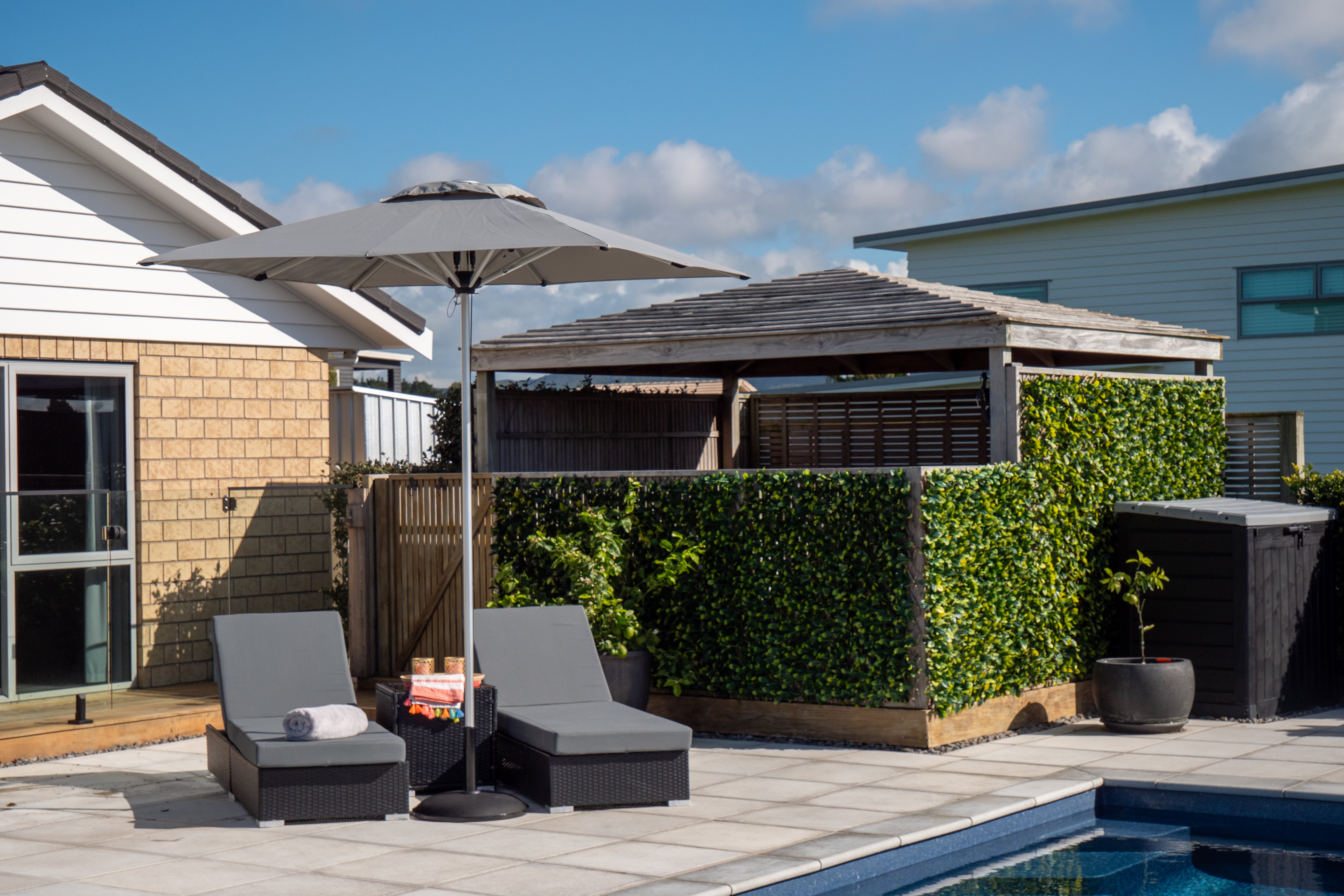 Shadowspec Oasis commercial market umbrella in a home garden setting