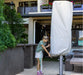 Shadowspec Protection Cover fitted over a closed SU10 commercial centre pole umbrella on a cafe patio