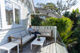 Shadowspec Retreat umbrella over an outdoor deck lounge