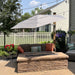Shadowspec Retreat wall-mounted umbrella with an Alpine Stone canopy over a backyard patio