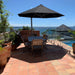 Shadowspec Serenity cantilever umbrella, octagon Black canopy on a Space Grey frame, over a terrace dining setting