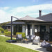 Shadowspec Serenity cantilever umbrella, square Alpine Stone canopy on a Heron Black frame, over a garden lounge