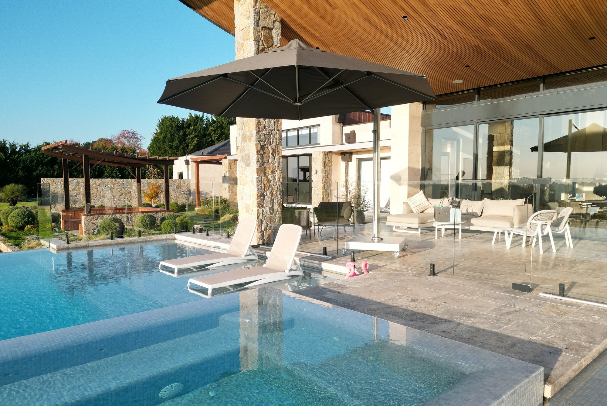 Shadowspec Serenity with a black canopy beside a swimming pool