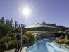 Shadowspec Serenity cantilever umbrella beside a pool in full sun