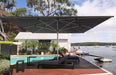 Shadowspec SU10 commercial centre pole umbrella, Charcoal Tweed canopy over a poolside deck