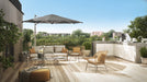 Shadowspec SU4 tilting offset umbrella in grey over a rooftop lounge setting