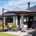 Shadowspec SU4 square offset umbrella with grey canopy over an outdoor lounge setting