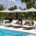 Shadowspec Unity twin-canopy cantilever umbrella over poolside loungers