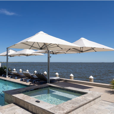 Shadowspec Unity multi-canopy cantilever umbrellas over a waterside deck