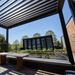 Black SkyFlex Delta motorised aluminium louvred pergola above a modern rooftop lounge area.