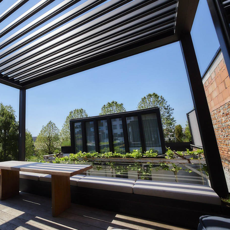 Black SkyFlex Delta motorised aluminium louvred pergola above a modern rooftop lounge area.