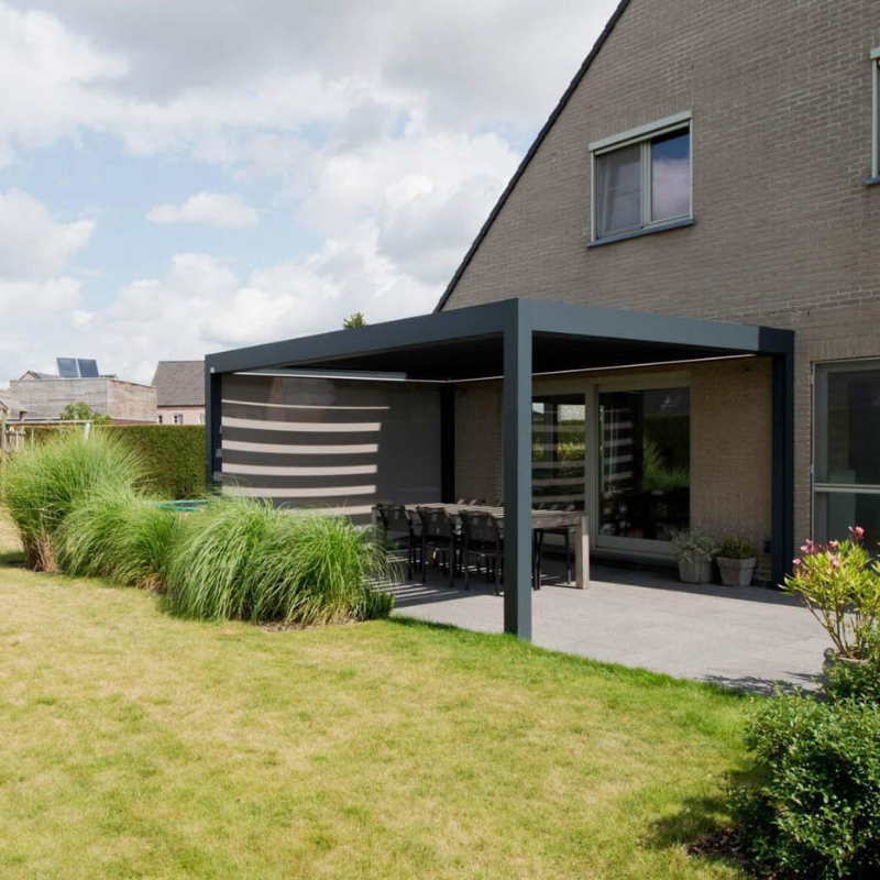 Black SkyFlex Delta motorised aluminium louvred pergola with side screen covering a garden patio dining area