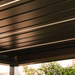 Close-up view of black pergola louvres with integrated LED strip lighting