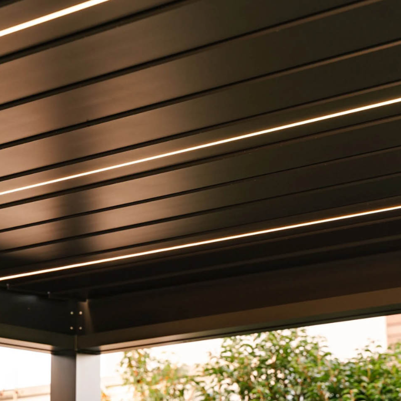 Close-up view of black pergola louvres with integrated LED strip lighting