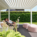 View from beneath a white SkyFlex Delta motorised aluminium louvred pergola covering a garden seating area