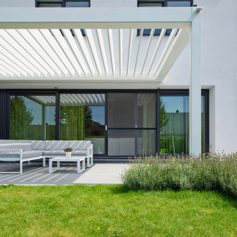 White SkyFlex Delta motorised aluminium louvred pergola attached to a modern home above an outdoor seating area