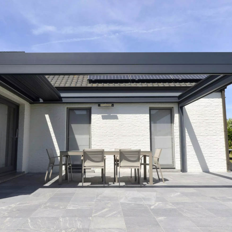 Grey SkyFlex Delta Open Sky motorised aluminium louvred pergola attached to a white brick house, covering a patio dining space