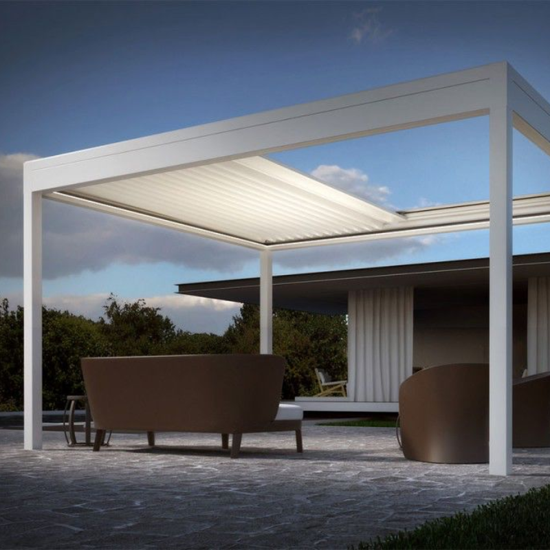 White SkyFlex Delta Open Sky motorised aluminium louvred pergola on a modern patio at dusk, sheltering an outdoor lounge area
