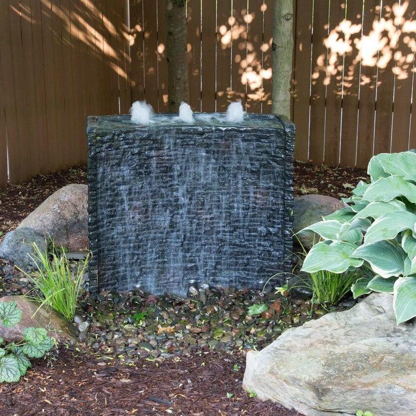 Curved Stacked Slate Spillway Wall fountain, 81cm, installed in a garden