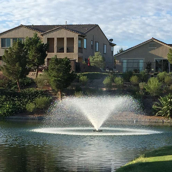 Otterbine Sunburst aerating fountain on a dam below a home