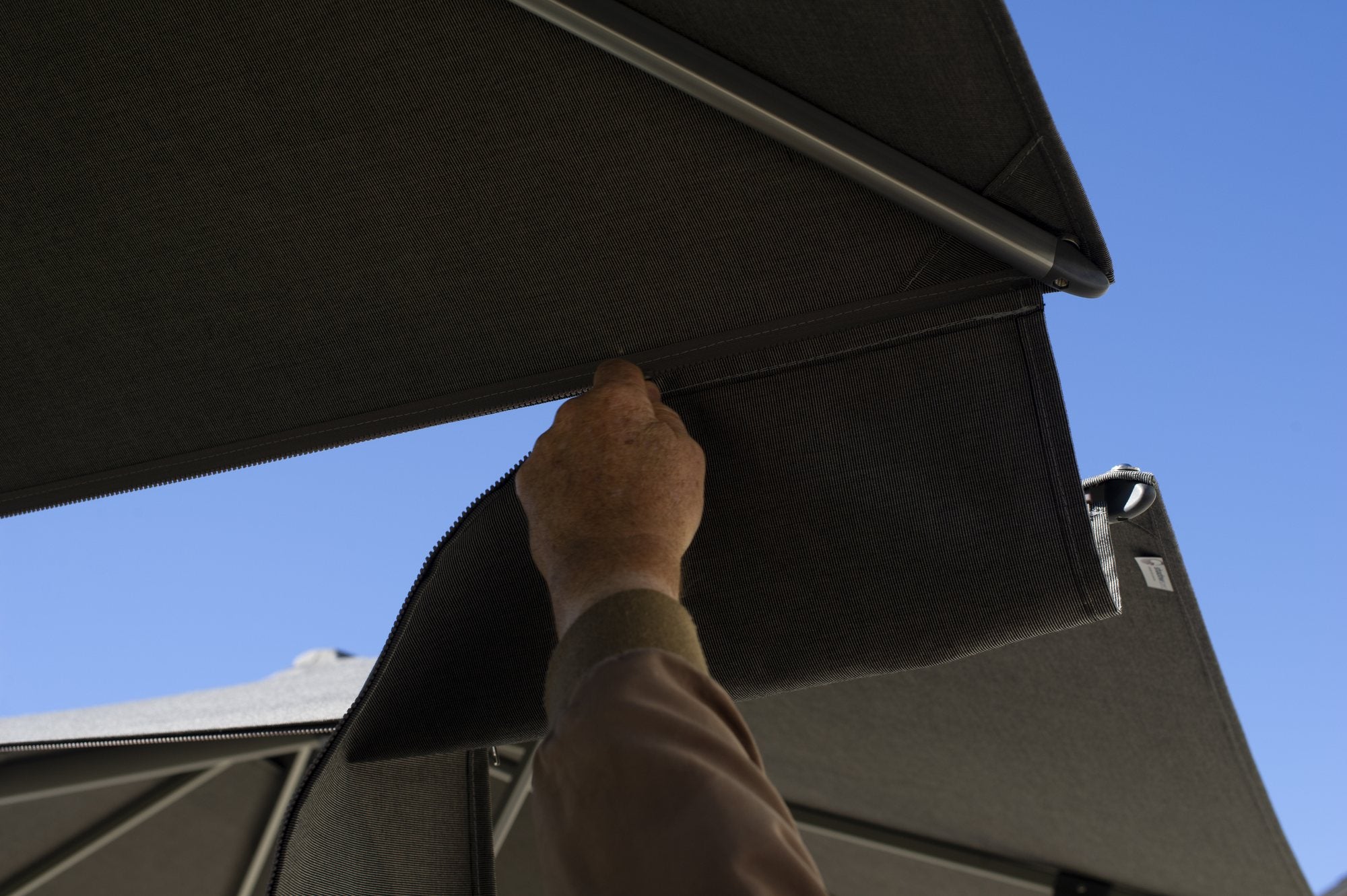 Rain gutter being fitted between two Shadowspec Unity canopies