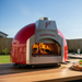 Valoriani Baby 75 Gas pizza oven, red powder-coated dome, cotto floor visible through the arch