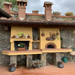 A family cooking together using a Valoriani pizza oven in an outdoor garden space.