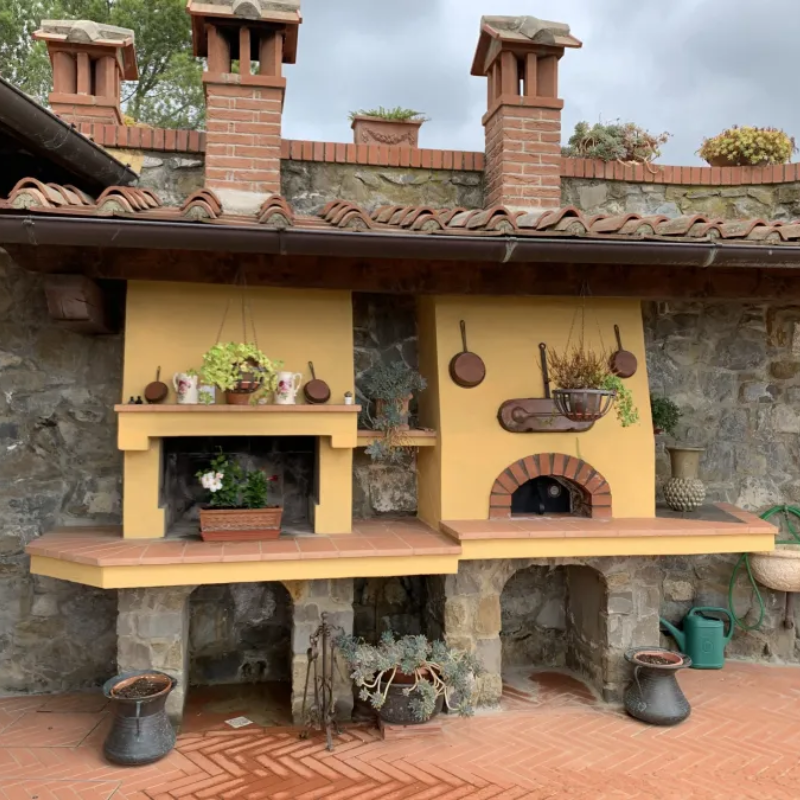 Technical assembly kit for the Valoriani FVR100 pizza oven, including components like flue, rain hat, and mortar for assembly.