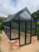 Winter Gardenz Elite 8ft x 12ft glasshouse on a recycled brick base wall, shown with a shade cover fitted